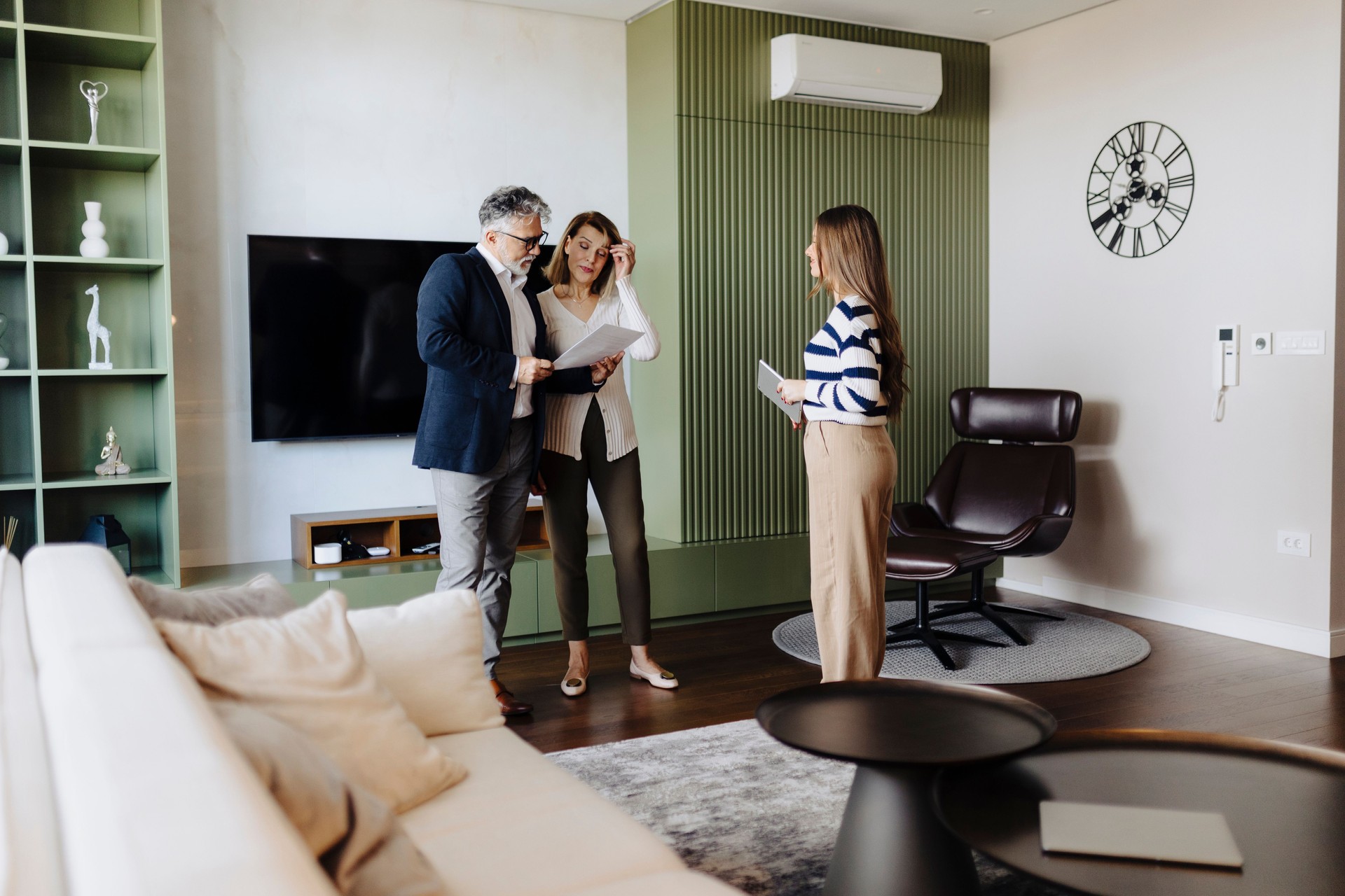 Senior couple talking with female financial or real estate advisor